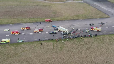 A road collision between a few cars and a bus